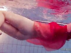 Redhead dancing in the pool