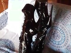 On a sofa wearing black sexy platform boots over the knees